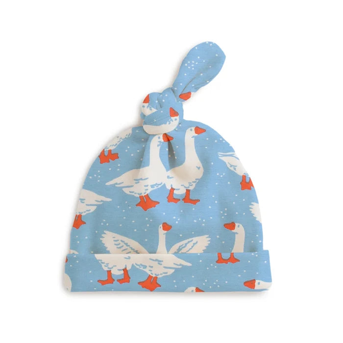 Baby hat with goose pattern on a light blue background